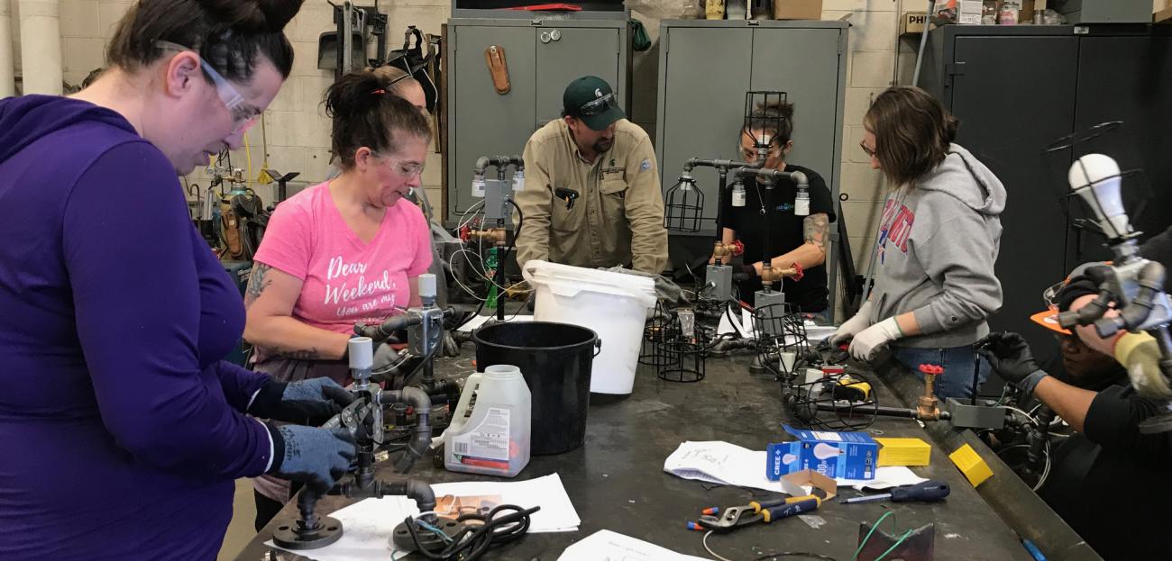 Women in Skilled Trades participants work with electrical equipment