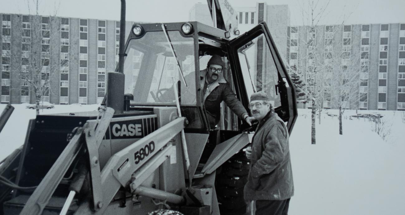 Photo of MSU grounds crew standing by tractor