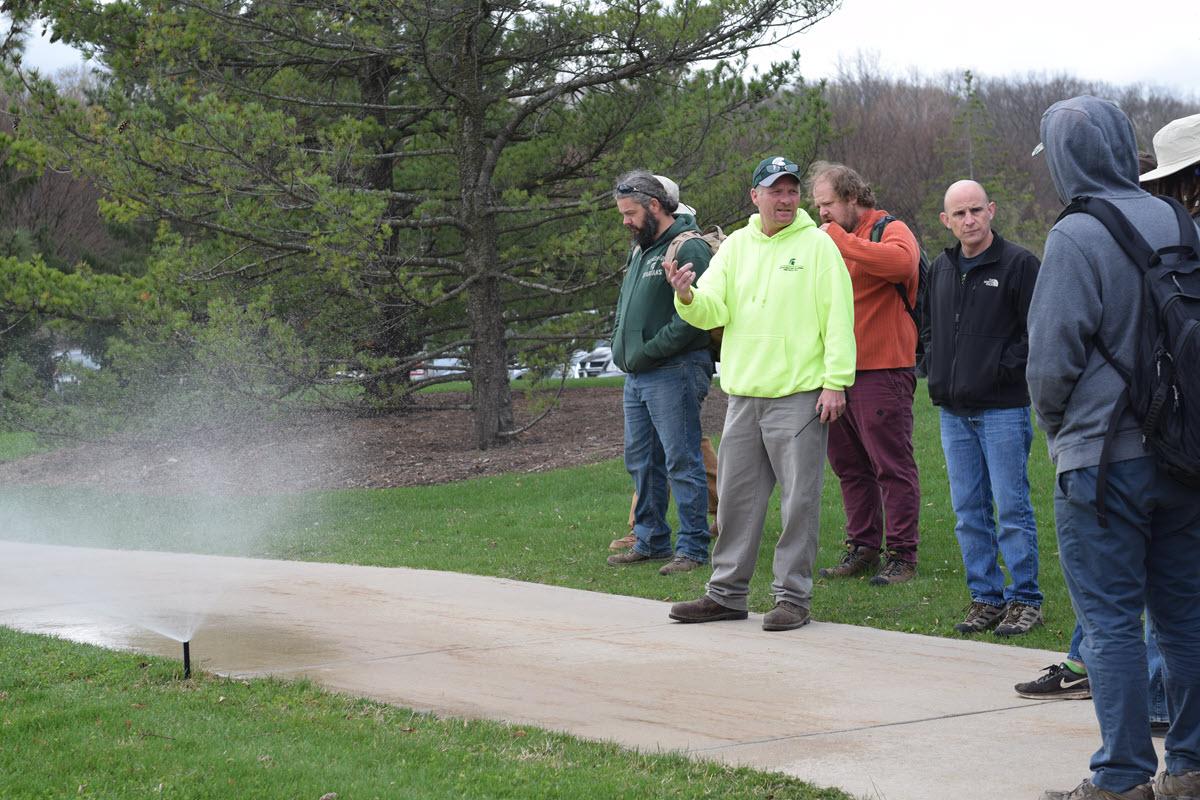 Derek Proulx demonstrating irrigation systems to Horticulture class