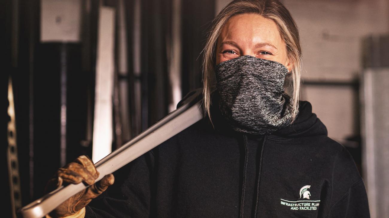 Lindsay Hasse, plumber, holds a wrench
