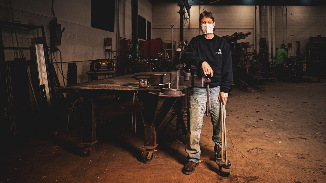 Marcie Nickols, preventative maintenance mechanic, holds a wrench