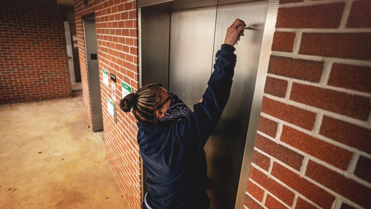 Melissa Peek, elevator mechanic, unlocks an elevator car