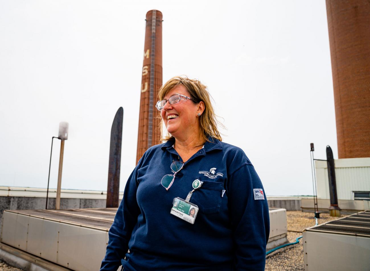 Donna Jones smiling in a blue IPF polo shirt on the roof of the power plant