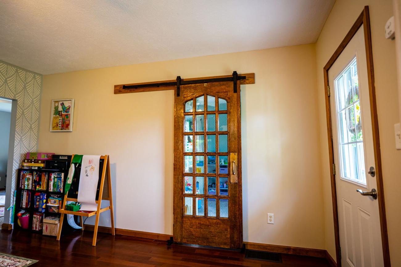 The fairchild theatre door hanging on a barn door track in the Thalls' home