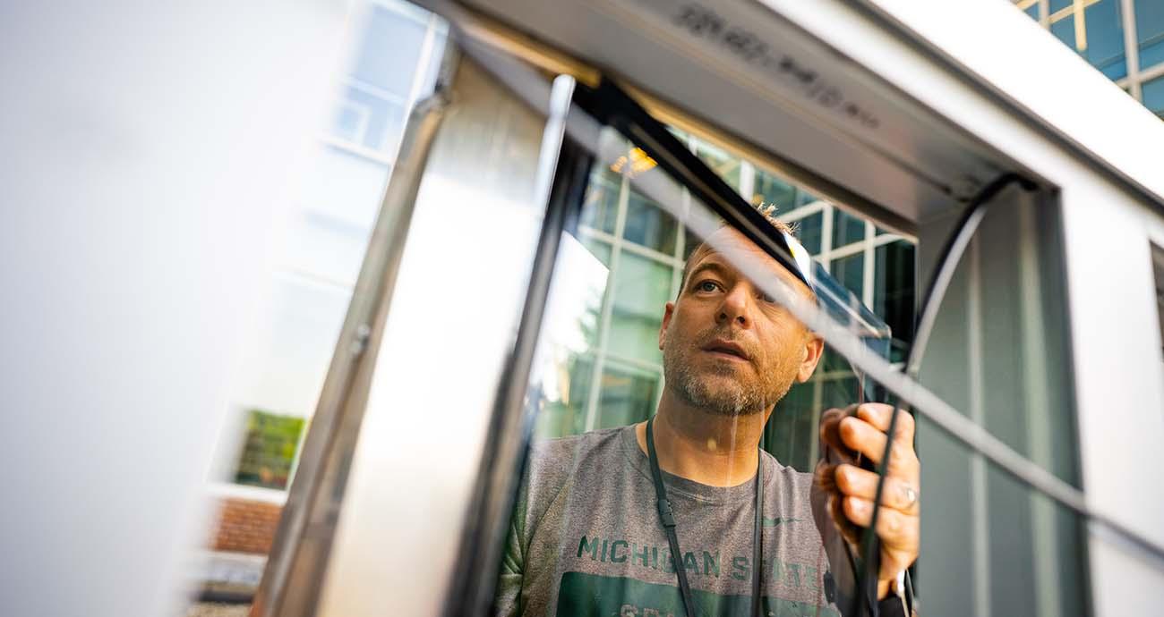 Glazier Chad Stowe installs solar glass panel