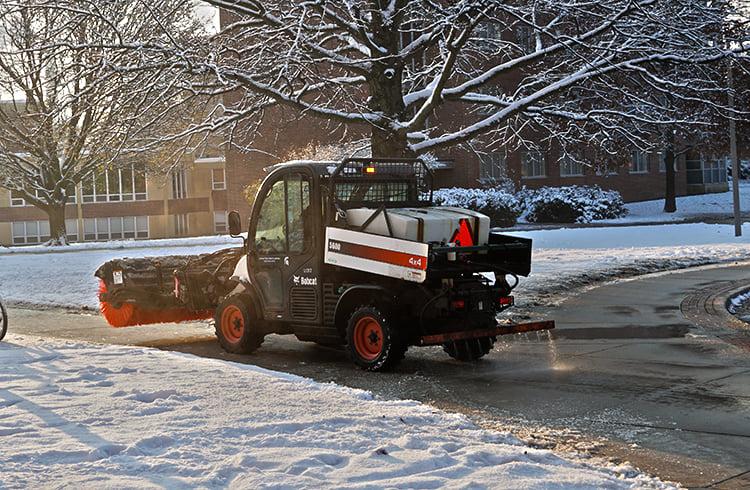 A IPF vehicle applies brine to campus walkways.