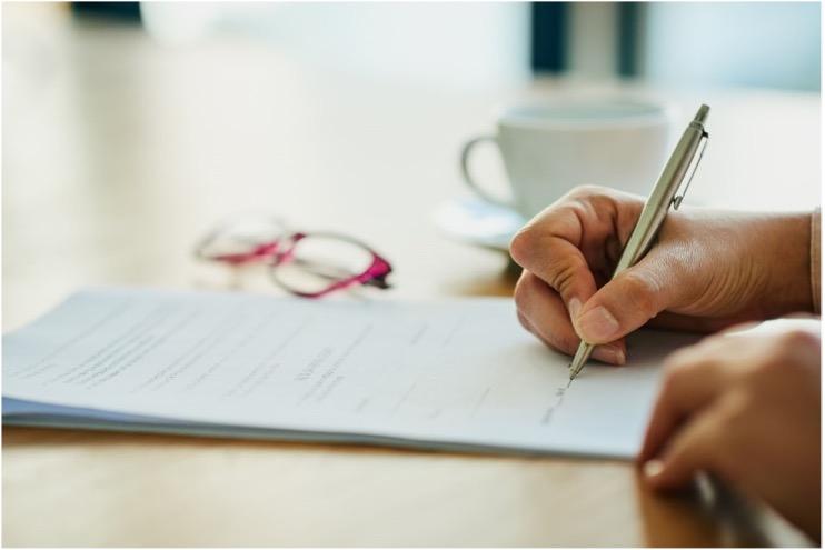 Person writing with a pen