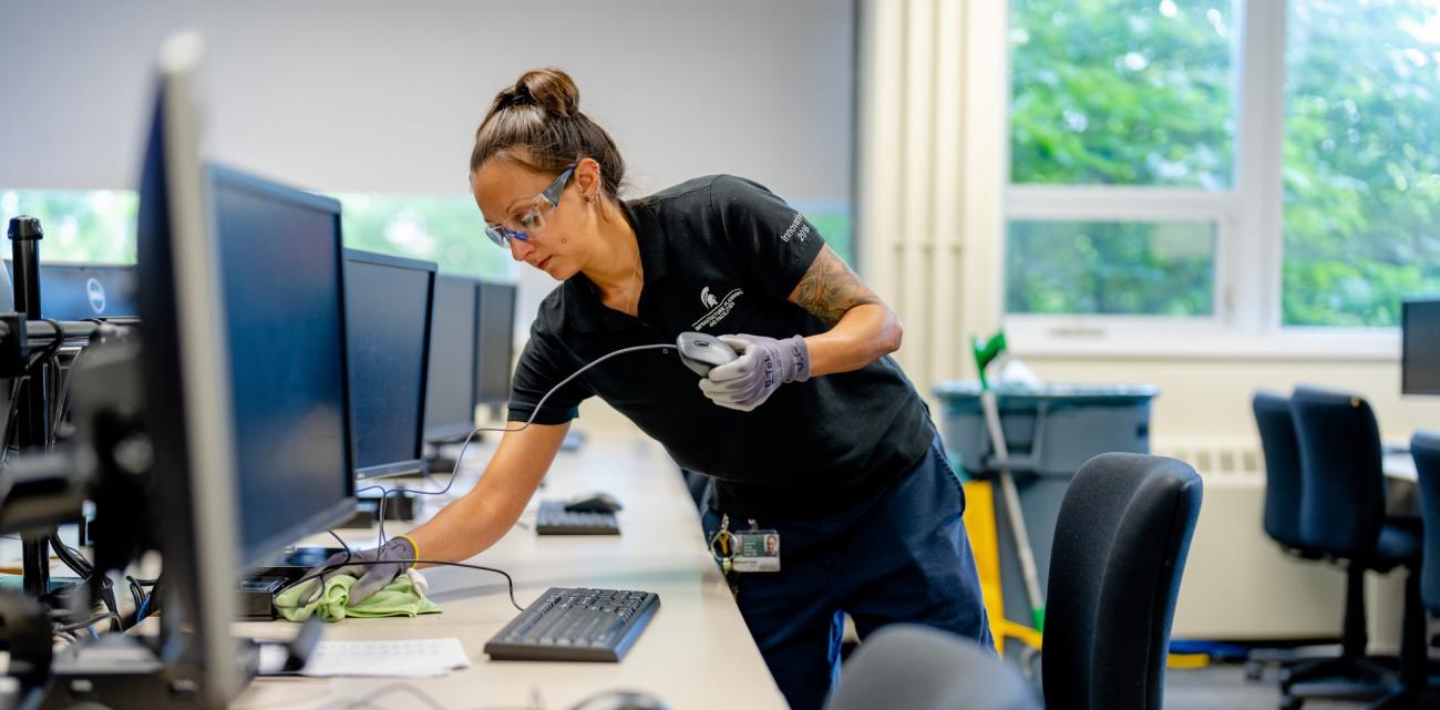 IPF custodian cleans a computer lab 