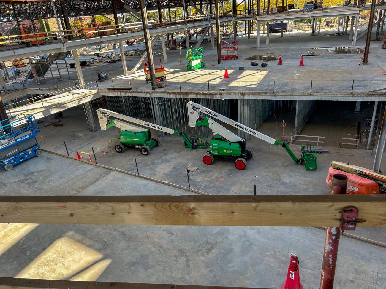 An open construction area with heavy machinery and concrete floors.