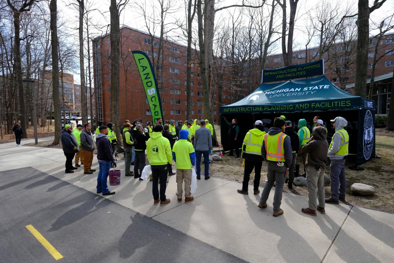 An IPF tent surrounded by staff in high-vis clothing.
