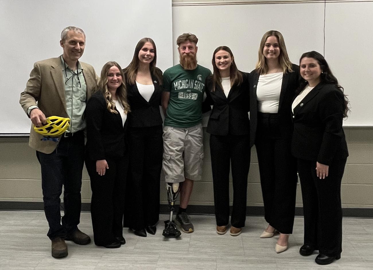 Tim Potter from MSU bikes (left) stands with Matthew Jolly (center) and MSU engineering students at Design Day.
