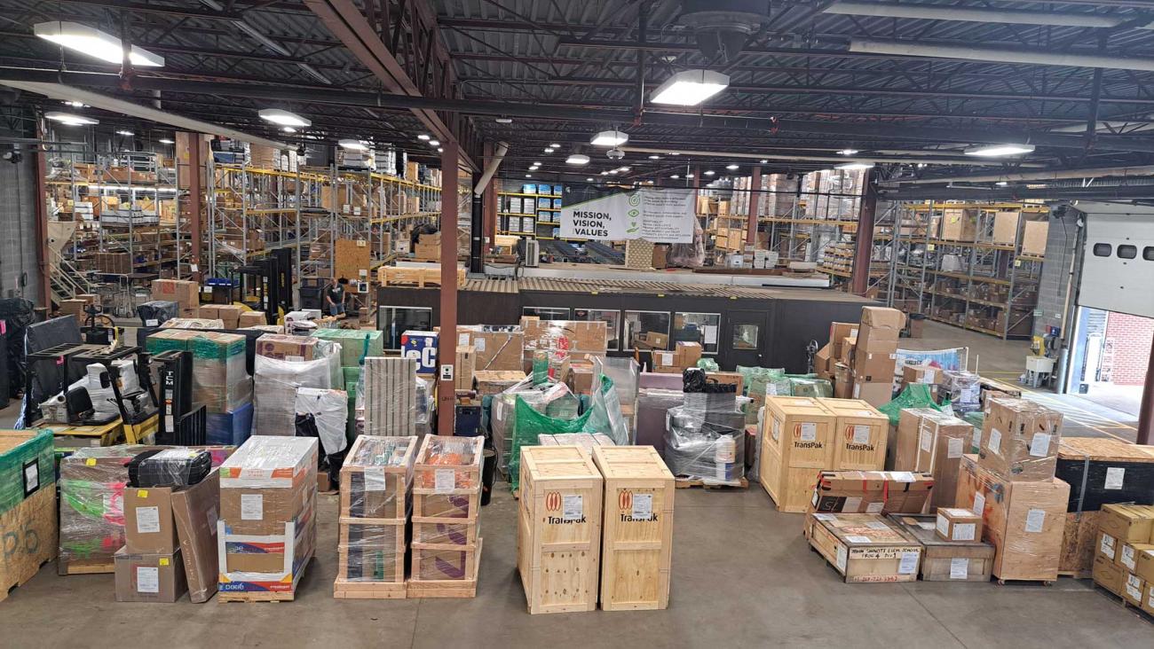 A large open warehouse full of boxes and shelving