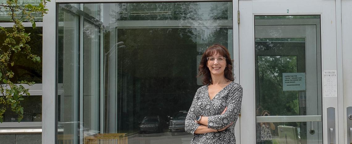 photo of sherri jett standing in front of the t.b. simon power plant