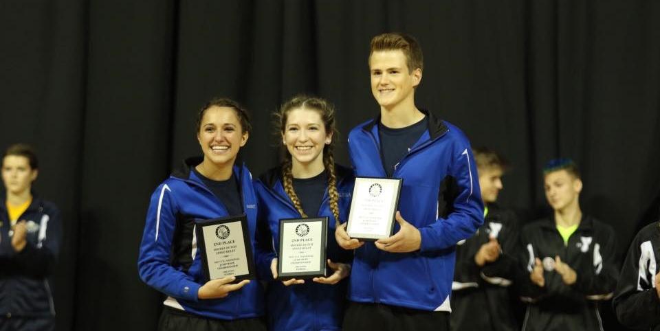 Kaileigh Hermann accepts an award with her teammates