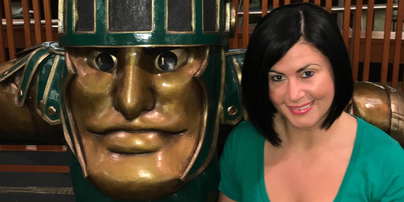 photo of stephanie redfern sitting at the sparty statue bench in the union
