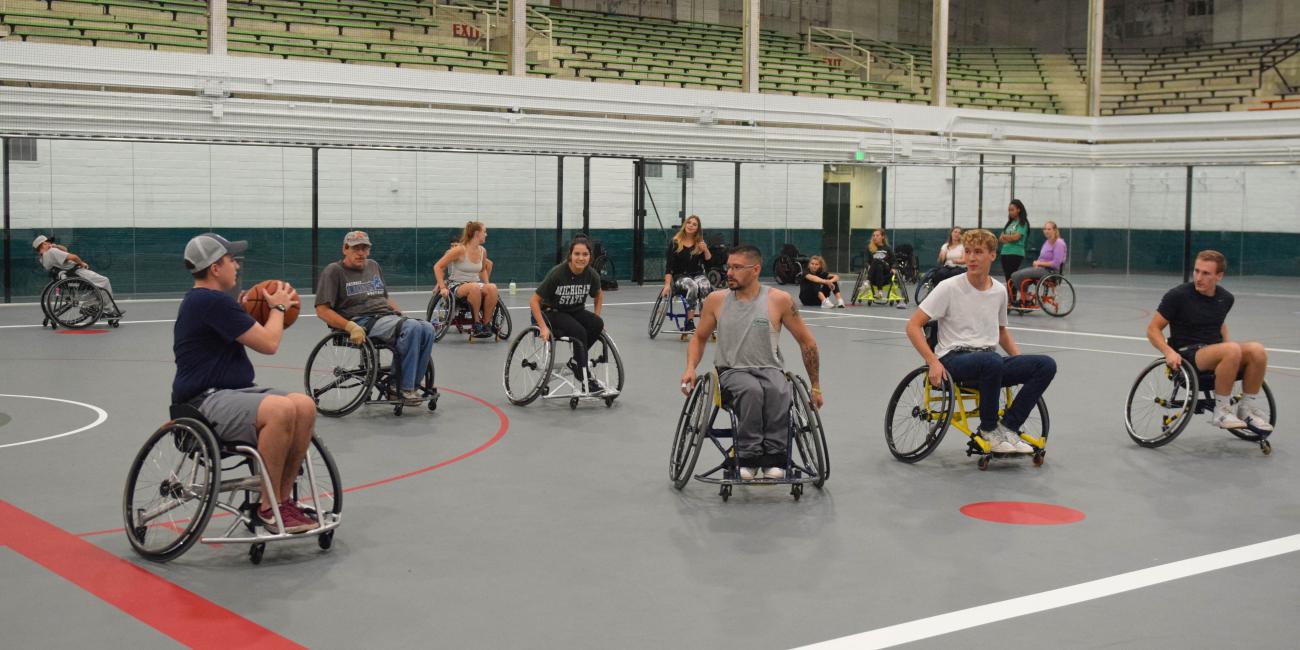 wheelchair basketball game in progress on new Demonstration Hall multi use court floor