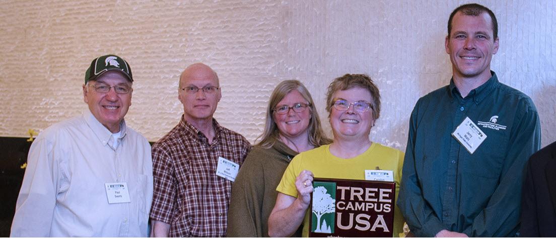 Photo of Paul Swartz, Jeff Wilson, Tressa Wahl, Carolyn Miller and Jerry Wahl accepting the Tree Campus USA award