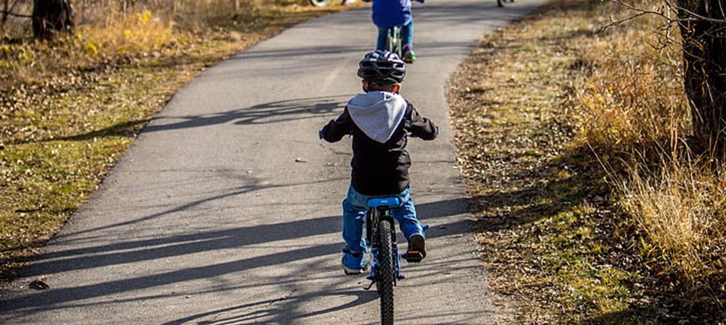 children bicycling on paved trail