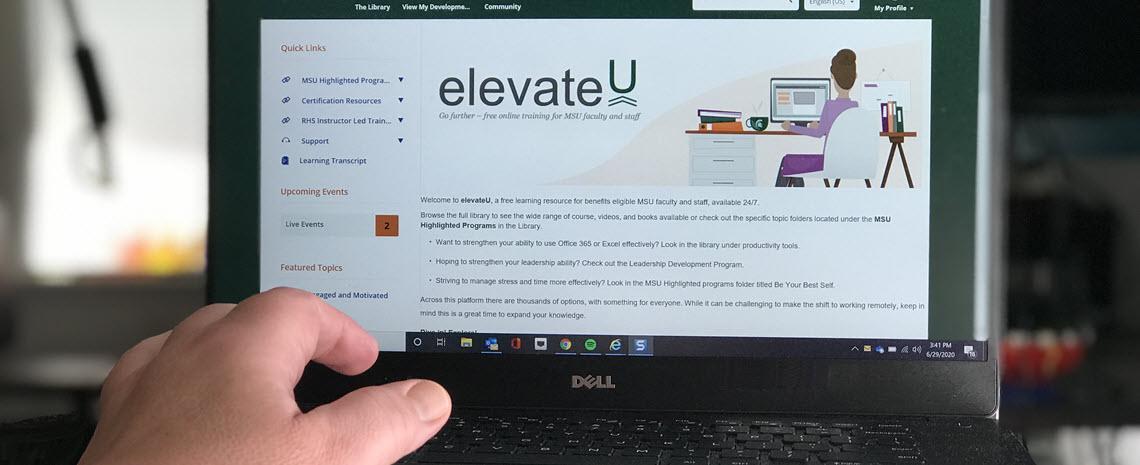 Photo of IPF employee accessing elevateU resources on a laptop computer