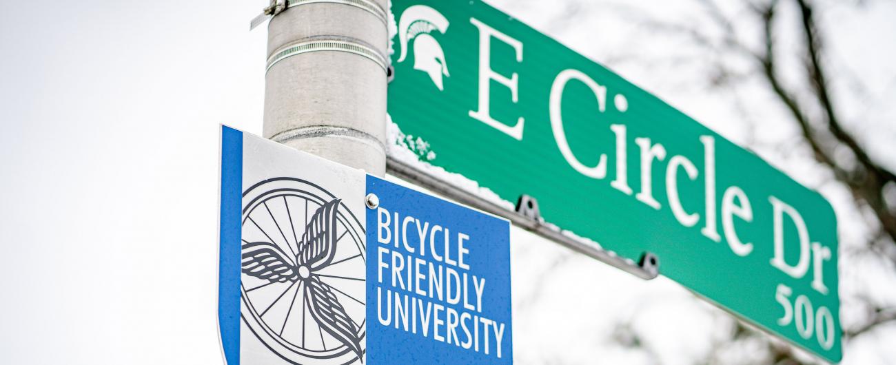Street sign of E Circle Dr on campus, with a "Bicycle Friendly University" sign beneath it