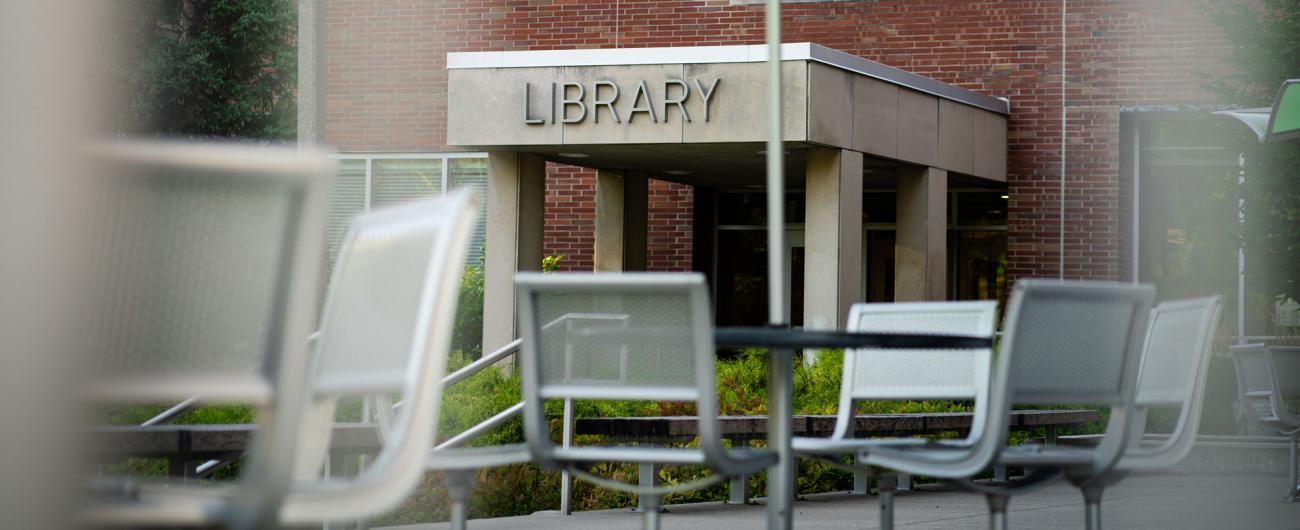 Entrance to the MSU Library with outdoor seating in the foreground