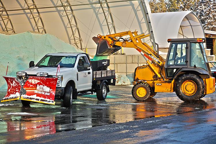 Loader filling a salt truck