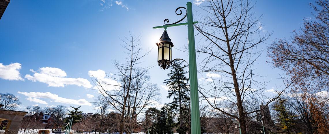 An MSU light pole against a blue sky
