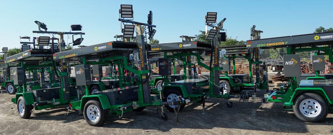 A row of solar light towers parked next to each other