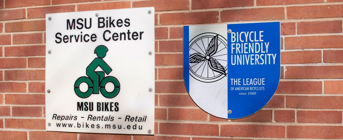 Brick wall with MSU Bikes and Bicycle Friendly University signs