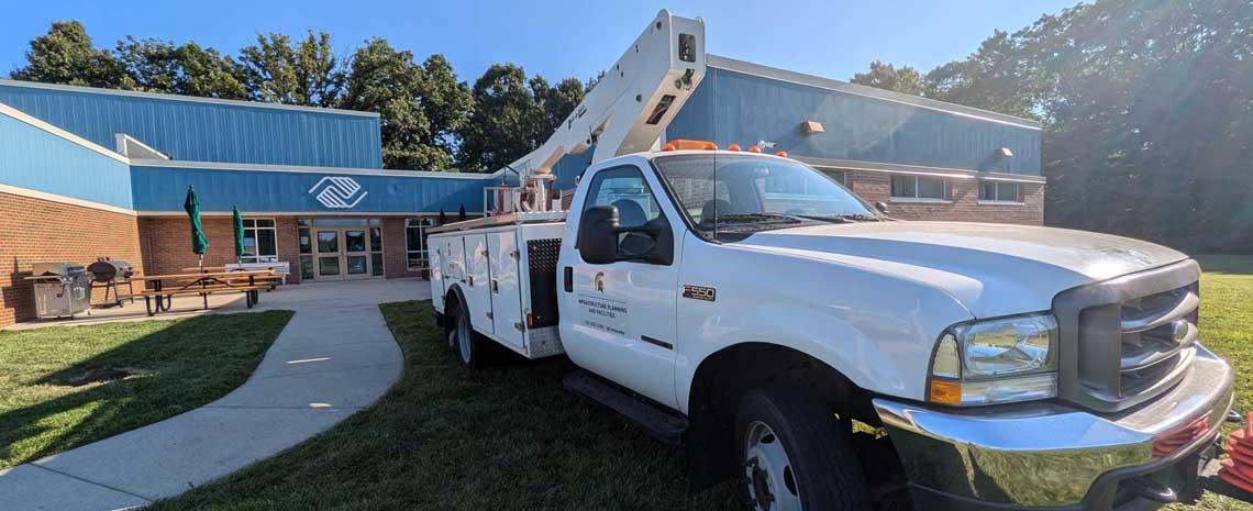 Landscape Services truck parked in front of Boys and Girls Club of Lansing