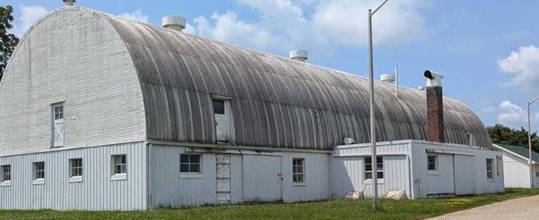 large white, domed building in disrepair