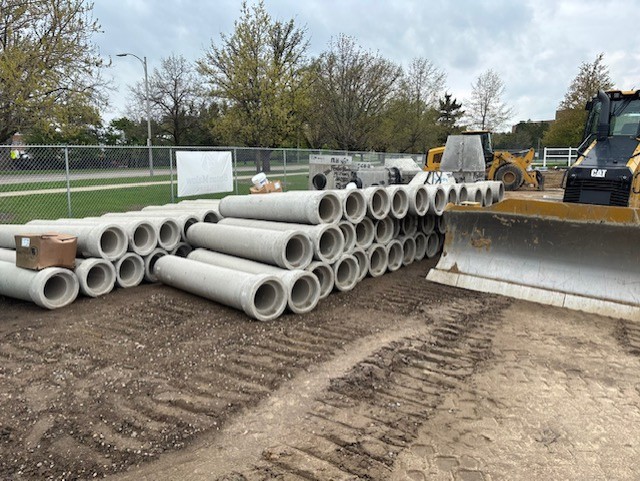 construction area with stack of large concrete pipes